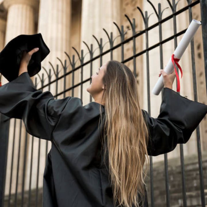 a girl with her degree in hand after she completed her graduation