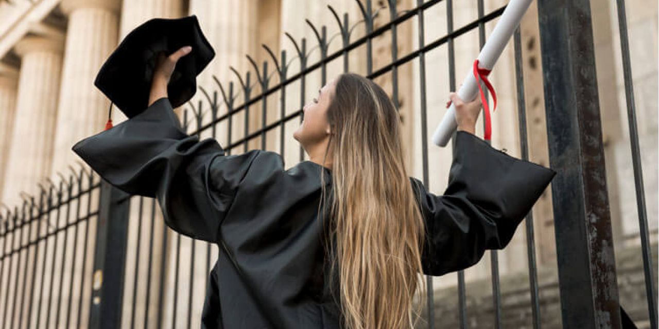 a girl with her degree in hand after she completed her graduation