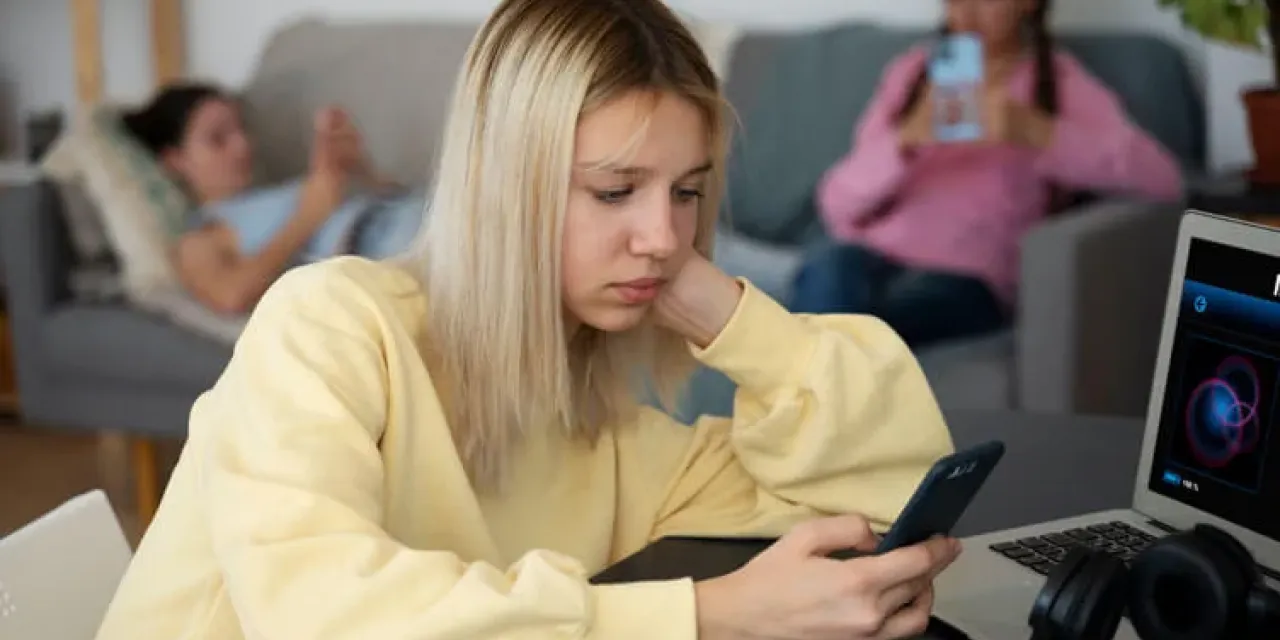 High angle girl holding smartphone