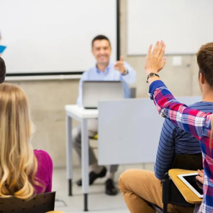 A student raising their hand to answer a question.