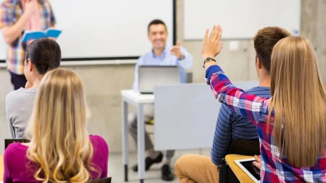 A student raising their hand to answer a question.