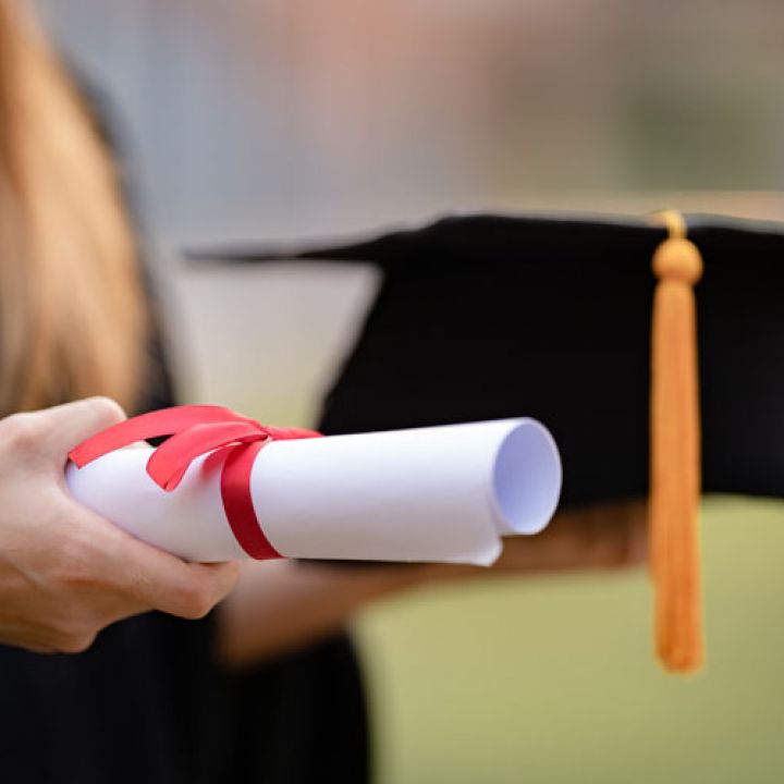 a student carrying his high school diploma