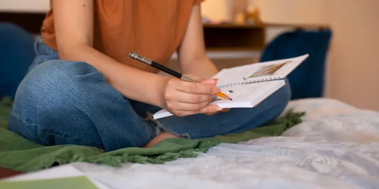 Side view woman doing creative journaling