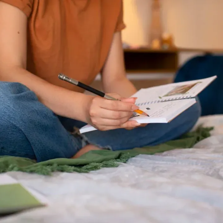 Side view woman doing creative journaling