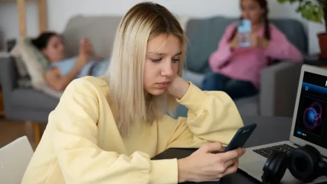 High angle girl holding smartphone