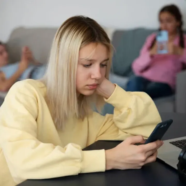 High angle girl holding smartphone